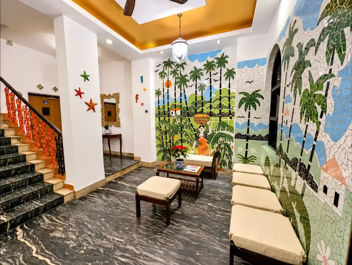 Mayfair Hotel common area with a colourful Goan mural